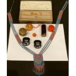 An Art Nouveau pin box; beadwork; a brass tape; needle case; etc