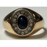 A 14ct gold ring, set with a central oval sapphire, surrounded by fourteen brilliant cut diamonds,