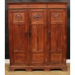 An 18th century style black walnut armoire or wardrobe, outswept cornice above three panel doors,