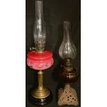 A Victorian brass and opaque glass table oil lamp, c.1890; another, cast iron base (2)