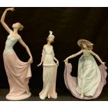 A Lladro figure, May Dance, designed by Jose Puche, number 5662; another, Talk of the Town, designed
