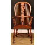 A 19th century Windsor elbow chair, hoop back, shaped and pierced splat, one-piece mid-rail,