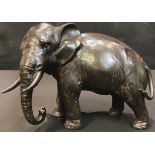 A Japanese bronzed metal sculpture of an elephant, character mark to base, 16.5cm high