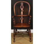 A 19th century Yorkshire Windsor elbow chair, hoop back, shaped and pierced Christmas tree splat,