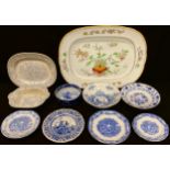 Blue and white tableware including meat plates, bowls, onion pattern warming plate; a large