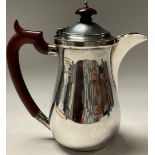 A silver baluster hot water pot, quite plain, domed cover, Chester, 1930, 18cm high