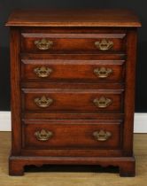 An oak chest of four long drawers, of small and neat proportions, by Titchmarsh & Goodwin, badged,