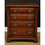 An oak chest of four long drawers, of small and neat proportions, by Titchmarsh & Goodwin, badged,