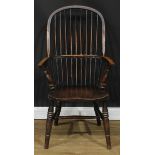 A 19th century beech and elm stick back Windsor elbow chair, hoop back, one-piece mid-rail, turned