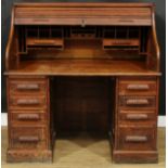 An early 20th century oak tambour roll top desk, 129cm high, 127cm wide, 81.5cm deep