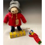 A Gabrielle Designs Paddington Bear, grey felt hat, red felt duffel coat, navy blue Wellington