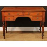 A Victorian mahogany writing table, crossbanded top above an arrangement of four cockbeaded drawers,