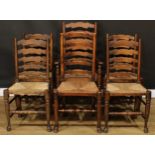 Six ladderback dining chairs, rush seats, the carver 107cm high, 56cm wide, the seat 43cm wide and