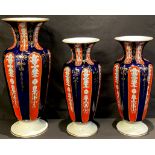 A garniture of three 19th century fluted vases, the largest 31cm high (3)