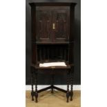 An unusual Jacobean Revival oak secretaire cabinet on stand, for the corner, 183cm high, 86cm