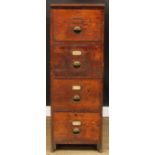 An early 20th century oak filing chest, of four drawers, brass cup handles, 130cm high, 45cm wide,