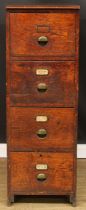 An early 20th century oak filing chest, of four drawers, brass cup handles, 130cm high, 45cm wide,
