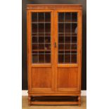 An early 20th century oak lead glazed library bookcase, blind fretwork frieze, 183cm high, 96cm