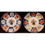 A near pair of Japanese export ware shaped circular Imari palette plates, 21.5cm diameter