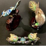 A Chinese parcel filigree and cloisonne enamel bird, holding a pearl, wooden stand, 12cm long;