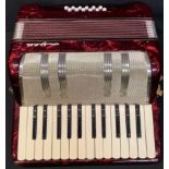 A Italian Ayra piano accordion, in red, cased, mid-20th century