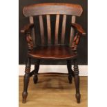 A Victorian beech and elm elbow chair, curved cresting rail, turned arm posts, saddle seat, turned