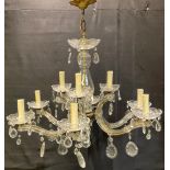 A cut glass and lacquered brass nine-light electrolier, multi-faceted droplets, 45cm high
