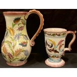 A Denby Glyn Colledge Glynware single handled jug, signed in green, 23cm; a similar smaller mug,