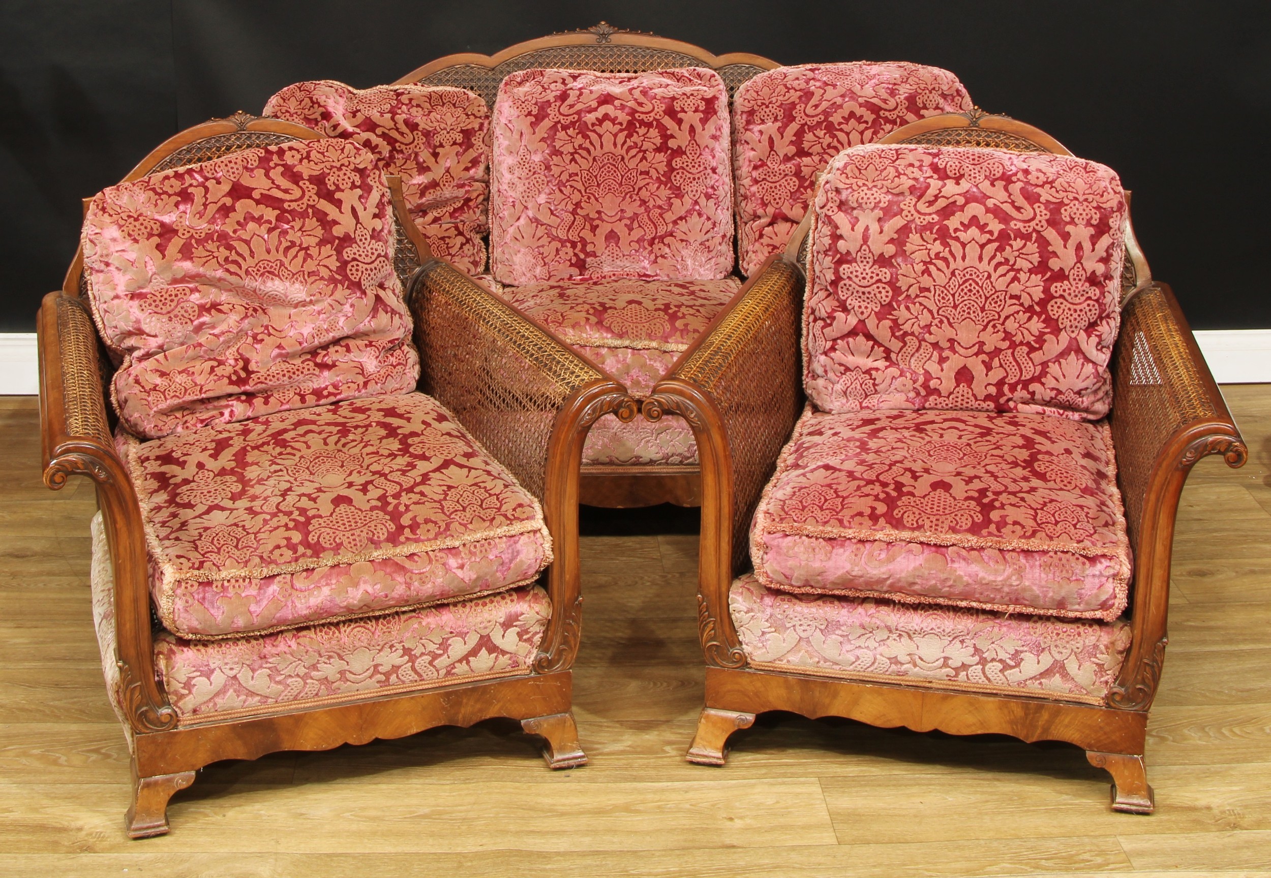 A three-piece bergère drawing room suite, composing sofa and a pair of chairs, the sofa 82cm high,