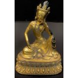 A contemporary gilt metal figure of a seated Deity, 20cm high, impressed leaf to base, 21cm high