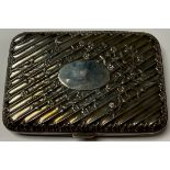 An Edwardian silver rounded rectangular cigarette case, spirally fluted and embossed with floral