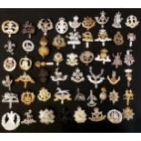 A collection of military cap badges, various regiments (approx 52)