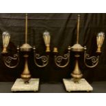 A pair of bronzed metal two light side lights, scroll arms, marble bases, 59cm high