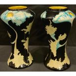 A pair of Black Ryden Papaver pattern waisted cylindrical vases, incised with flowing foliate stems,