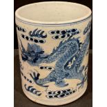 A Chinese blue and white brush pot, decorated with dragon chasing pearl of wisdom, 14cm high