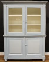A Victorian painted pine housekeeper’s cupboard, outswept cornice above a pair of glazed doors