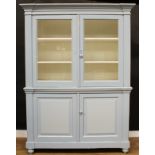 A Victorian painted pine housekeeper’s cupboard, outswept cornice above a pair of glazed doors