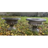 A lotus cast shallow campana shaped garden urn, plain everted rim, waisted wrythen base, square