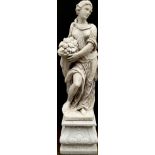 A large garden statue, of a lady, wearing flowing robes holding a fruiting cornucopia, on a