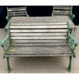 A heavy cast iron and wooden slatted garden table, bench, two chairs and stool, 155cm wide, 68.5cm