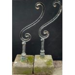 A pair of 19th century cast iron garden balustrade ends, the S scrolls supported on turned