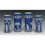 A pair of 19th century Wedgwood Jasperware cylindrical vases, typically sprigged with classical