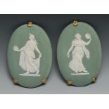 A pair of 19th century Wedgwood Jasperware oval plaque, typically sprigged in white with classical