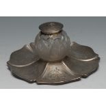 A Victorian silver shaped circular ink stand, the frosted glass well cut with stylised leaves, the