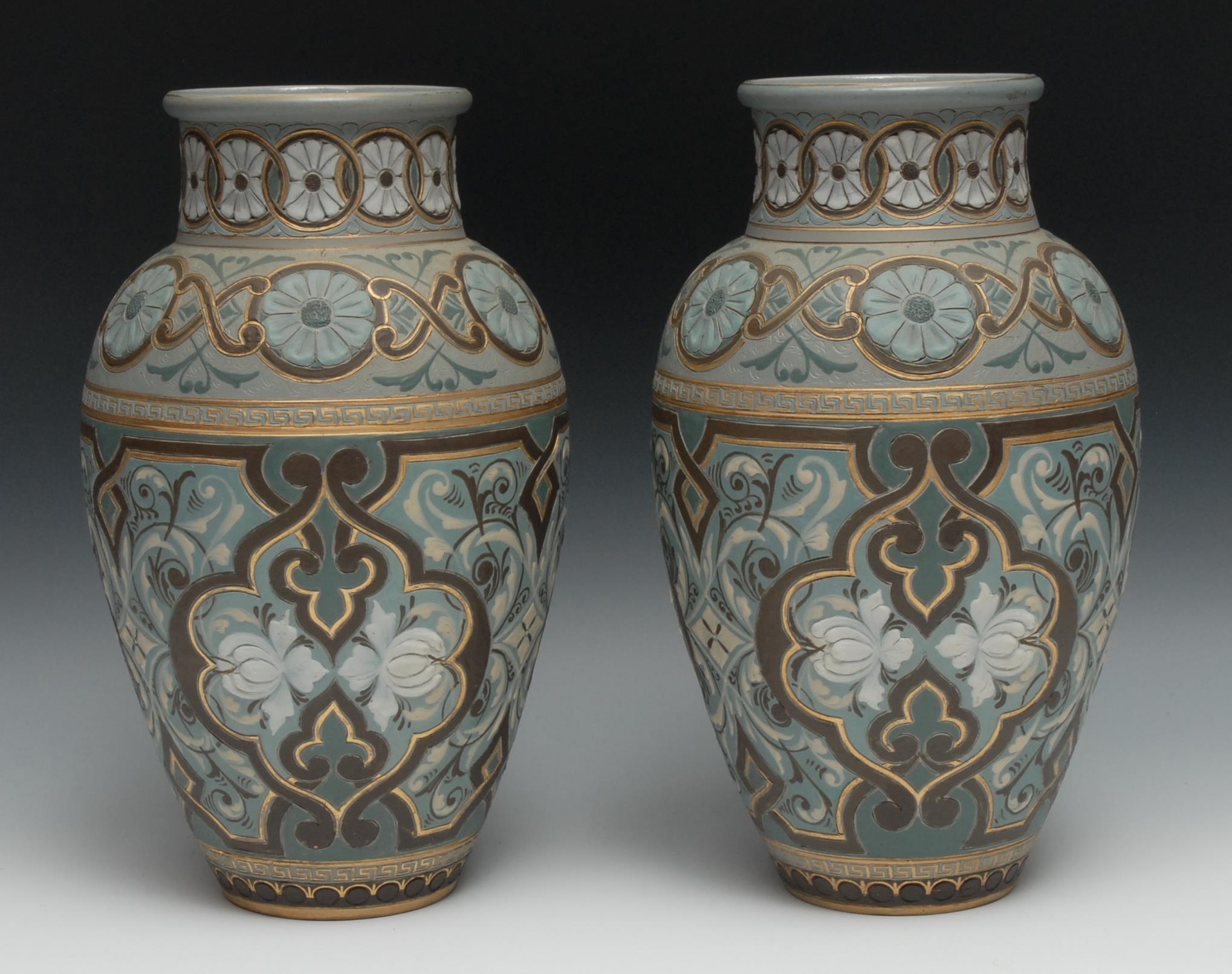 A pair of Doulton Lambeth Silicon vases, incised with and in relief with flowers, and scrolls, in