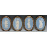 A pair of 19th century Wedgwood Jasperware oval plaques, typically sprigged with classical figures