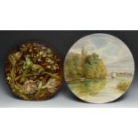 A Doulton Lambeth Aesthetic Movement circular charger, painted impasto with birds on a blossoming