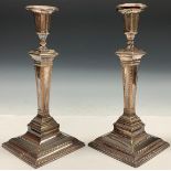 A pair of George III Old Sheffield Plate square table candlesticks, campana sconces, fluted