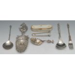 A large Dutch silver straining or sifting spoon, the terminal cast as Teniers type tavern dweller,