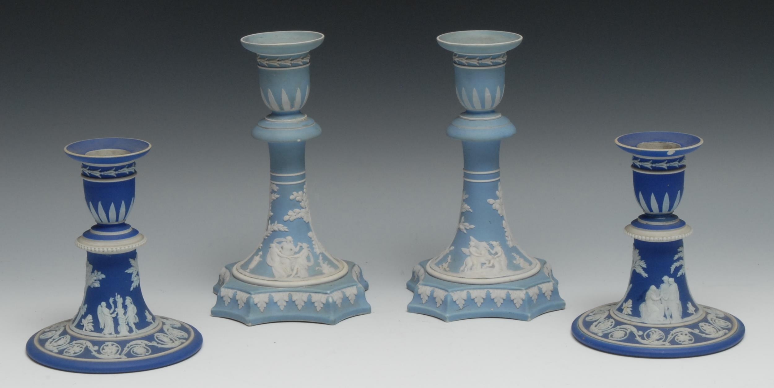 A pair of 19th century Wedgwood Jasperware candlesticks, typically sprigged with classical